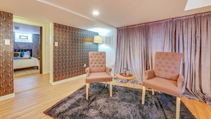 A modern living room with two armchairs, a small round table, and a patterned rug. - Pittsburgh Couple's Retreat ~ 2 Mi to Downtown! (Pittsburgh)