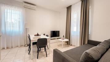 Family Apartment, 2 Bedrooms, Terrace | Living area | 43-inch LCD TV with satellite channels