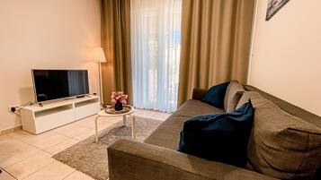 Superior Apartment | Living area | 43-inch LCD TV with satellite channels