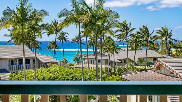 A beachfront property with multiple buildings, palm trees, and a view of the ocean. - Newly Renovated, Ocean Views, Minutes to Beach (Koloa)