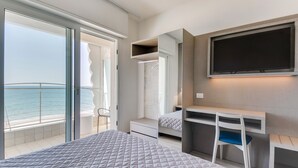 A modern bedroom with a bed, a desk, a chair, and a TV. - Marittimo Riccione (Riccione)