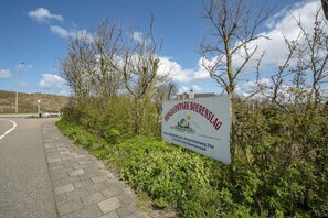 Escape to a serene rural retreat at Bungalowpark Boerenslag, surrounded by lush greenery and leafy trees.