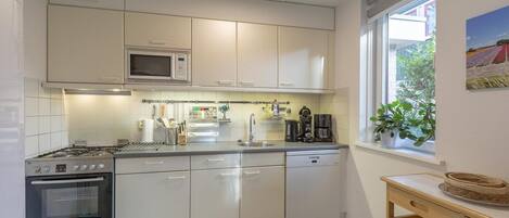 Dishwasher, coffee/tea maker, toaster, dining tables