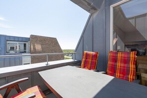 Enjoy a peaceful retreat on this balcony with a flat table and two comfortable chairs.