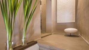 A bathroom with a white sink, a mirror, and two tall green plants in glass vases. - Immersed in the silence of the Tuscan countryside, the Superior apartment offers an unspoiled view of the Tuscan countryside.Equipped with a kitchenette, living room, private bathroom and 2 bedrooms, 1 double bed and 1 queen bed, it offers: stove, refrig (Siena)