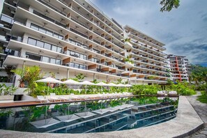 River-side pool with multiple cabanas and lounge chairs - Two Pools, Bar & Gym | Casa Medianoche at Oasis (Puerto Vallarta)