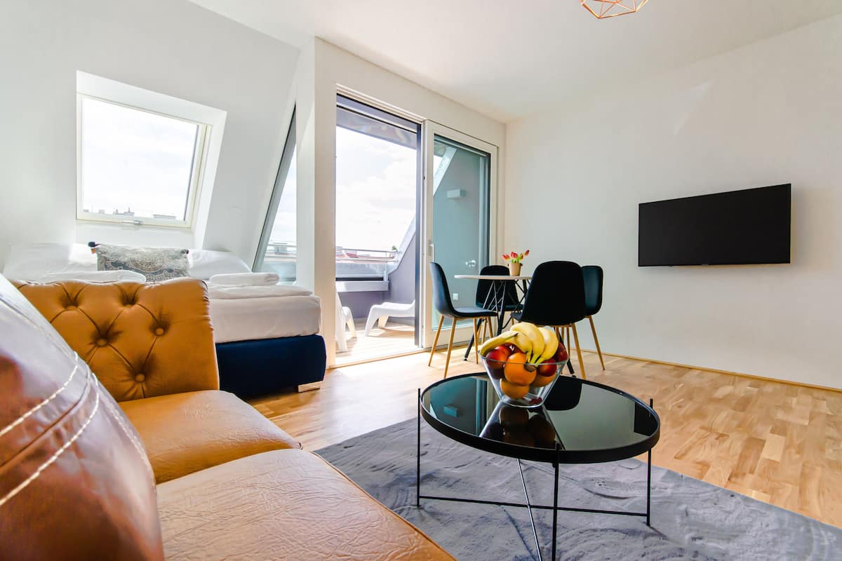 Deluxe Apartment, 1 Bedroom, Balcony | Living area | 40-inch Smart TV with cable channels, heated floors