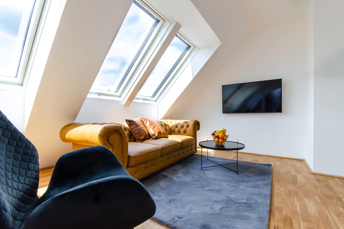 Penthouse Apartment with Balcony | Living area | 40-inch Smart TV with cable channels, heated floors