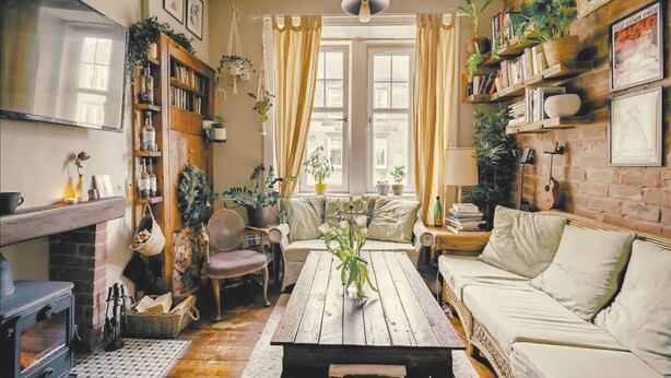 A cozy living room with a fireplace, wooden coffee table, and comfortable seating.