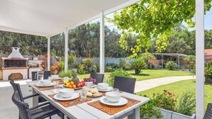 An outdoor patio with a dining table set for four, surrounded by wicker chairs. - Villa Teo - Four Bedroom Villa, Sleeps 8 (Ionian Islands)