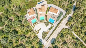 An aerial view of a resort with multiple buildings, swimming pools, and a winding road. - Villa Ira Lefkas - One Bedroom Villa, Sleeps 2 (Lefkada)