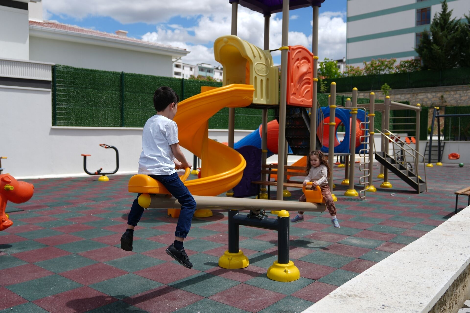 A playground with a slide and climbing structures.