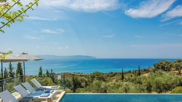 A pool with a view of the sea, lounge chairs, and a pergola. - Mounda Beach Villa - Four Bedroom Villa, Sleeps 7 (Ionian Islands)