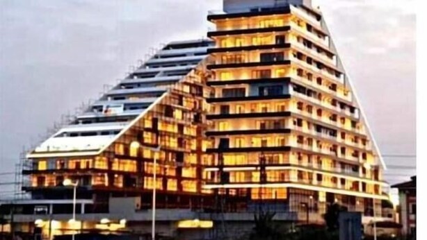A multi-story hotel with a unique angular design, featuring balconies on each floor.