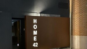 La entrada de un edificio con un letrero que dice "HOME 42".