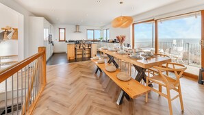 A spacious kitchen with a central island, large windows, and a balcony with a view. - 5 bedroom accommodation in Berwick-Upon-Tweed (Berwick-Upon-Tweed)