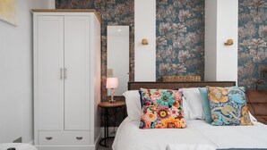 A bedroom with a bed, a wardrobe, a round table, and a mirror. - Aldgate London City Boutique Cosy Studio 4 (London)