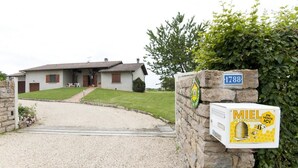 A house with a stone wall and a mailbox.