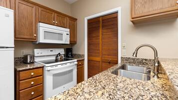 Fridge, microwave, coffee/tea maker, cookware/dishes/utensils