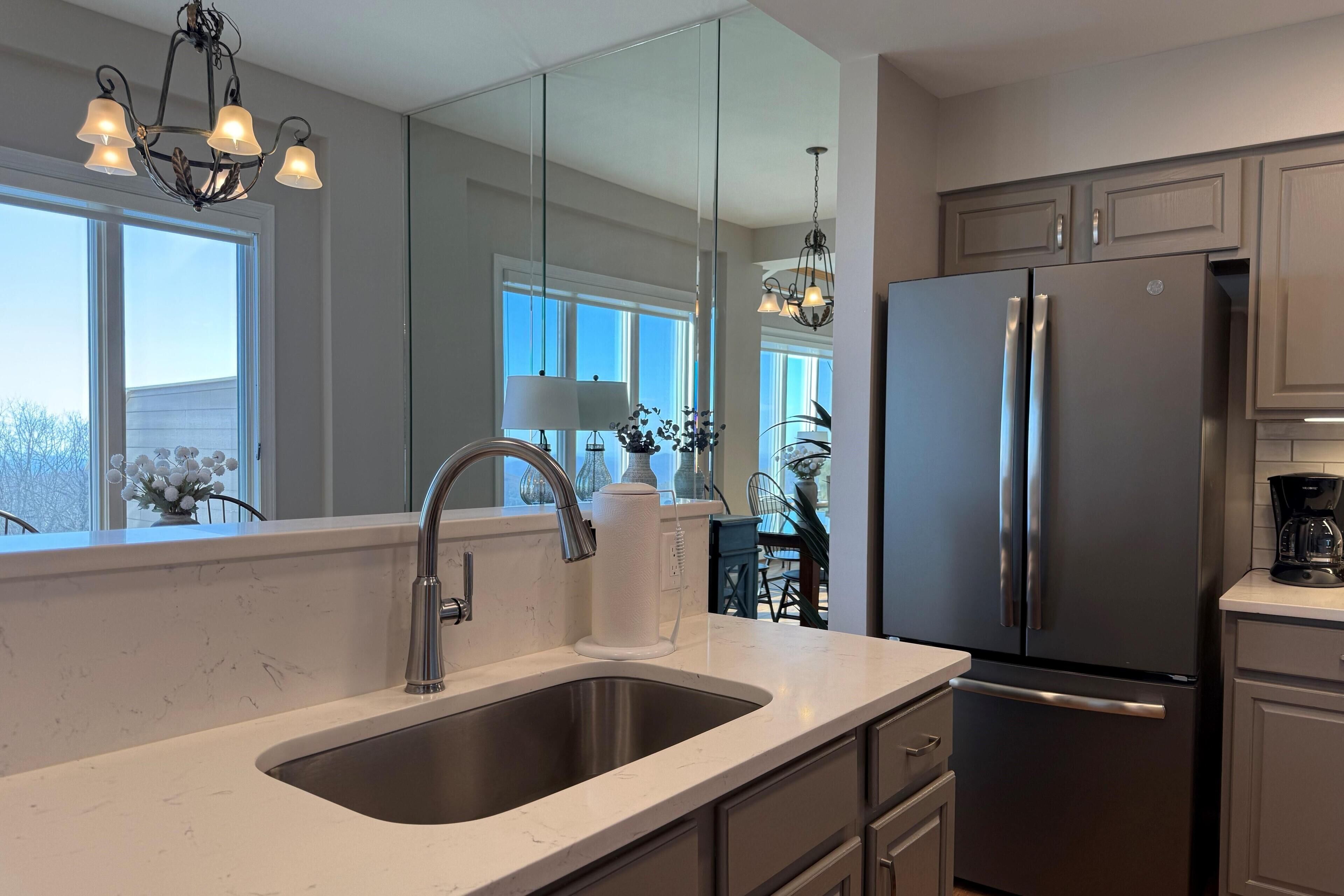 Fridge, microwave, coffee/tea maker, cookware/dishes/utensils