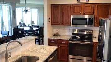 Fridge, microwave, coffee/tea maker, cookware/dishes/utensils