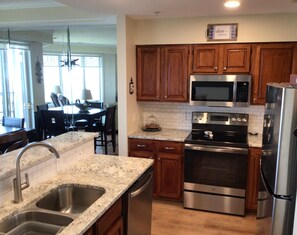 Fridge, microwave, coffee/tea maker, cookware/dishes/utensils