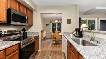 Fridge, microwave, coffee/tea maker, cookware/dishes/utensils