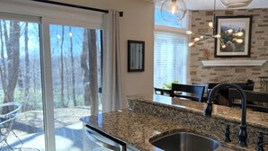 A kitchen with granite countertops, stainless steel sinks, and a dishwasher.