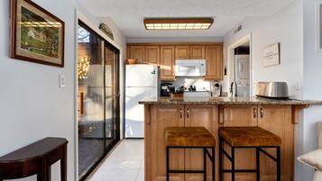 Fridge, microwave, coffee/tea maker, cookware/dishes/utensils