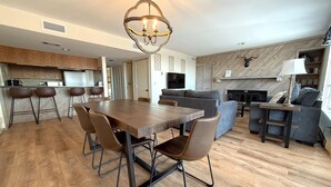 A modern living space with a dining area, kitchen, and seating area. - Highlands 05 with Wintergreen Advantage (Wintergreen)