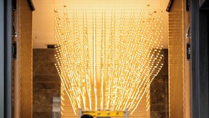 A man and a woman walking through a hallway with a modern light installation. - Boreas Hotel & SPA, Trademark Collection by Wyndham (Ankara)