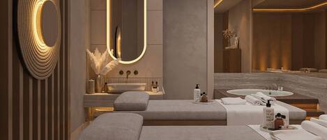 A modern bathroom with a large mirror, a sink, and a bathtub. There are towels and toiletries on the counter.