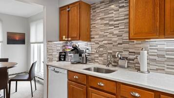 Fridge, microwave, coffee/tea maker, cookware/dishes/utensils