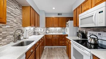 Fridge, microwave, coffee/tea maker, cookware/dishes/utensils