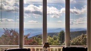 A room with large windows offering a view of a mountainous landscape. - Highridge Court 19 with Wintergreen Advantage (Wintergreen)