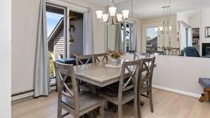 A dining area with a wooden table, chairs, and a chandelier. - Northridge 09 with Wintergreen Advantage (Wintergreen)