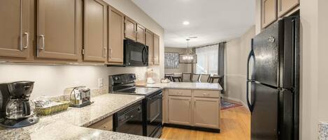 Fridge, microwave, coffee/tea maker, cookware/dishes/utensils