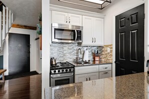Fridge, microwave, coffee/tea maker, cookware/dishes/utensils