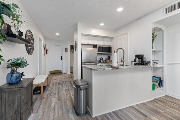 Fridge, microwave, coffee/tea maker, cookware/dishes/utensils