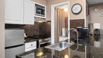 Fridge, microwave, coffee/tea maker, cookware/dishes/utensils