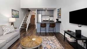 A modern apartment with a living room, kitchen, and a staircase. - Timbers Lodge 57 with Wintergreen Advantage (Wintergreen)