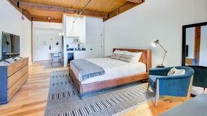 A bedroom with a wooden ceiling, a bed with a patterned rug, a desk, and a chair. - Mountain Inn Studio 96 with Wintergreen Advantage (Wintergreen)