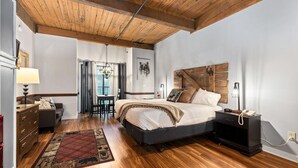 A bedroom with a wooden ceiling, a bed with a headboard, a dresser, a nightstand, and a rug. - Mountain Inn Studio 97 with Wintergreen Advantage (Wintergreen)