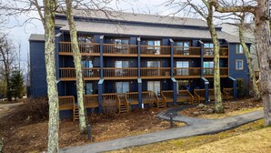 A multi-story building with balconies and a pathway leading to the entrance. - Timbers Studio 38 with Wintergreen Advantage (Wintergreen)