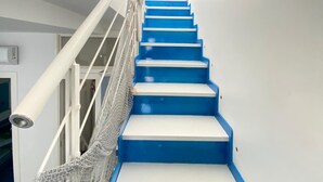 A staircase with blue steps and white risers, leading to a landing. - Arime Apartment
Elegance and Tradition a Stone's Throw from the Sea" (Lacco Ameno)