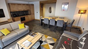 A modern living room with a sofa, coffee table, and dining area with chairs. - 2nd floor, view mountain, balcony, tv, 81m², La Plagne (Aime)