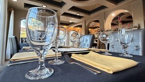 A dining area with tables set for two, featuring clear glassware and a dark tablecloth. - Elevate Your Experience: Ocean Lodge Unveiled (St Simons Island)