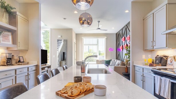 A modern kitchen with a central island, built-in appliances, and a dining area with chairs. - Huge Private Rooftop Deck w/ Firepit + Putt-putt 8 Mins to Broadway Doralee (Nashville)