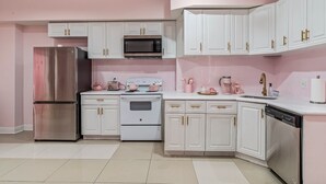 A kitchen with white cabinets, stainless steel appliances, and pink accents. - GIRLS SUITE w/ BALL PIT! 3 THEMED BEDROOMS & 2 BATH located in CHINATOWN  (Philadelphia)