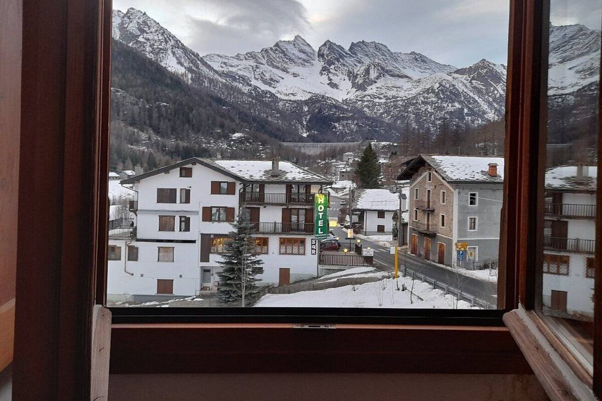 A hotel with a view of snow-covered mountains.